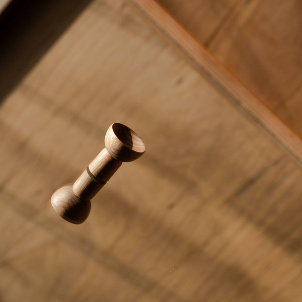 Wooden door handle on mirrored surface
